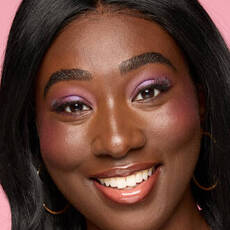 Model wearing NYX Make’em Wonder™ Foundation in shade 43 Deep Ebony with luminous finish and pink shimmer eye look.