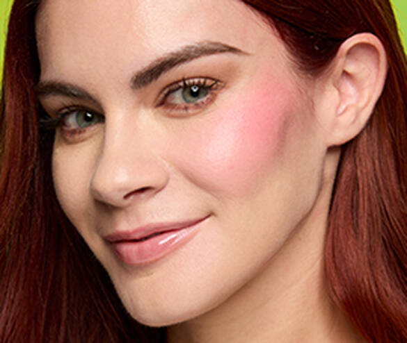 Closeup of woman wearing Fat Cheeks Juicy Blush in both shade Guava Gush and shade Papaya Plump