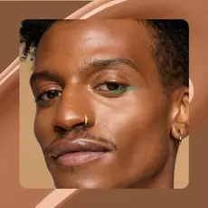 Close-up of model wearing Wonder Snatch(TM) Concealer in Shade 23 Sienna.