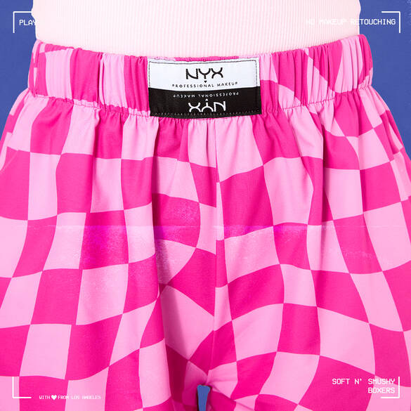 Color-blocked pink checker print boxers available in unisex sizes XS–XLG with an elastic waistband.