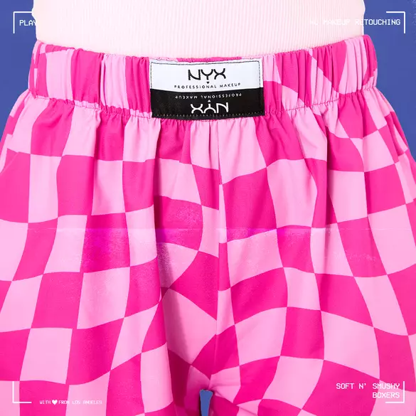 Color-blocked pink checker print boxers available in unisex sizes XS–XLG with an elastic waistband.