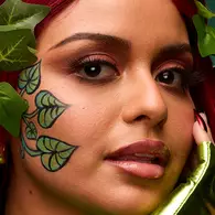 NYX Professional Makeup red Halloween look with sharp red graphic eyeliner, red eyeshadow, dark lips and a septum ring.