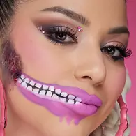 NYX Professional Makeup doll Halloween look with pink eyeshadow, a pink zipper-effect mouth and pearl face embellishments.
