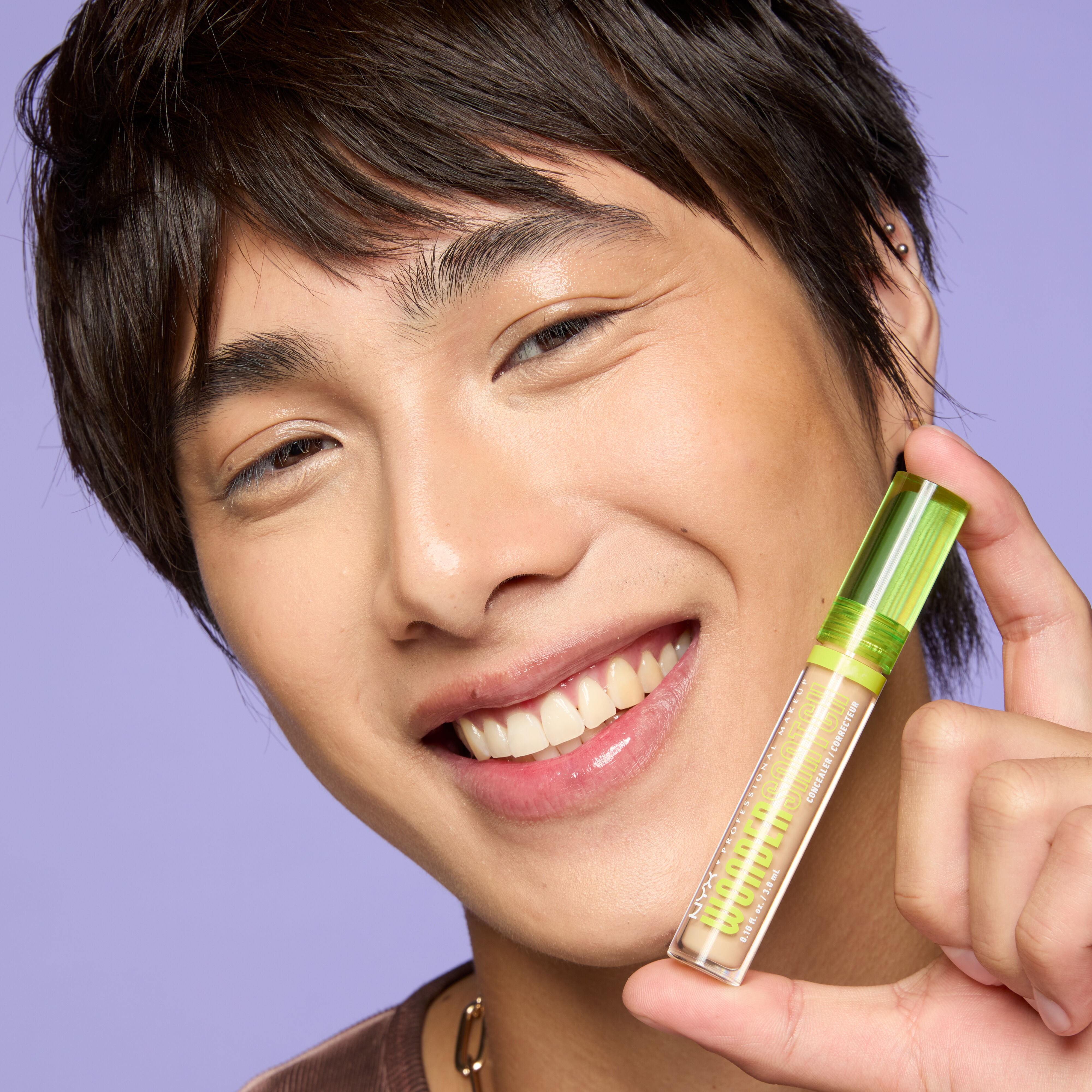 model holding bottle of wonder snatch concealer