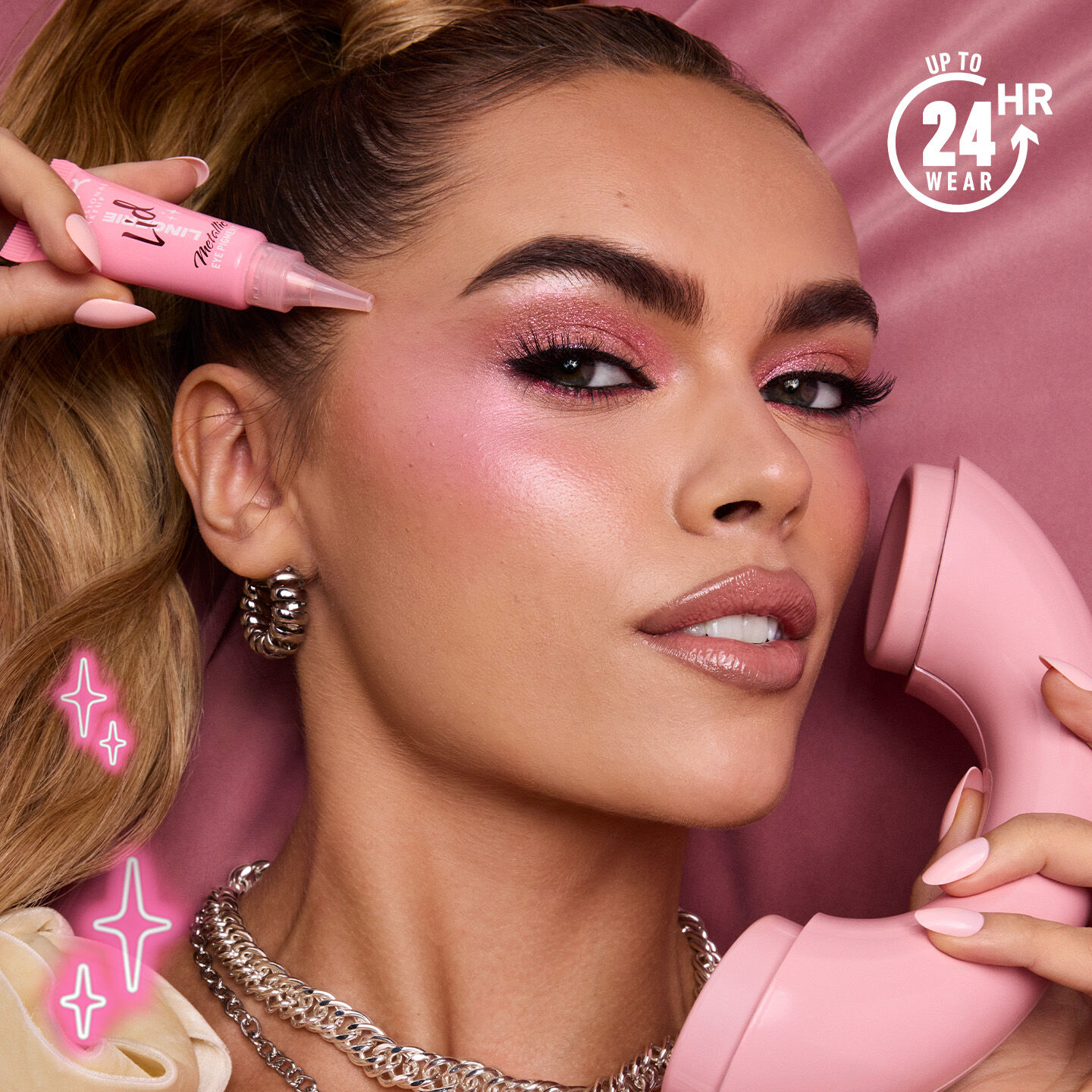 model on a pink phone holding a bottle of Lid Lingerie in pink