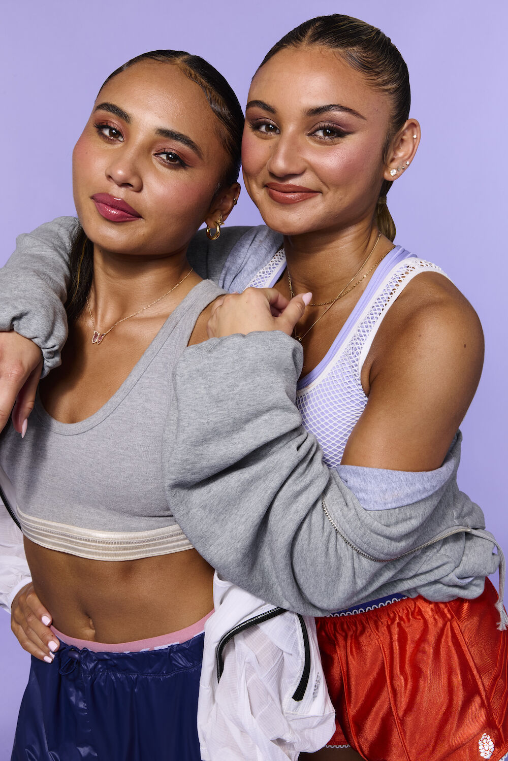Natonal Women's Soccer League athletes Alyssa and Gisele Thompson smiling and embracing each other, wearing workout clothes and NYX Professional Makeup.