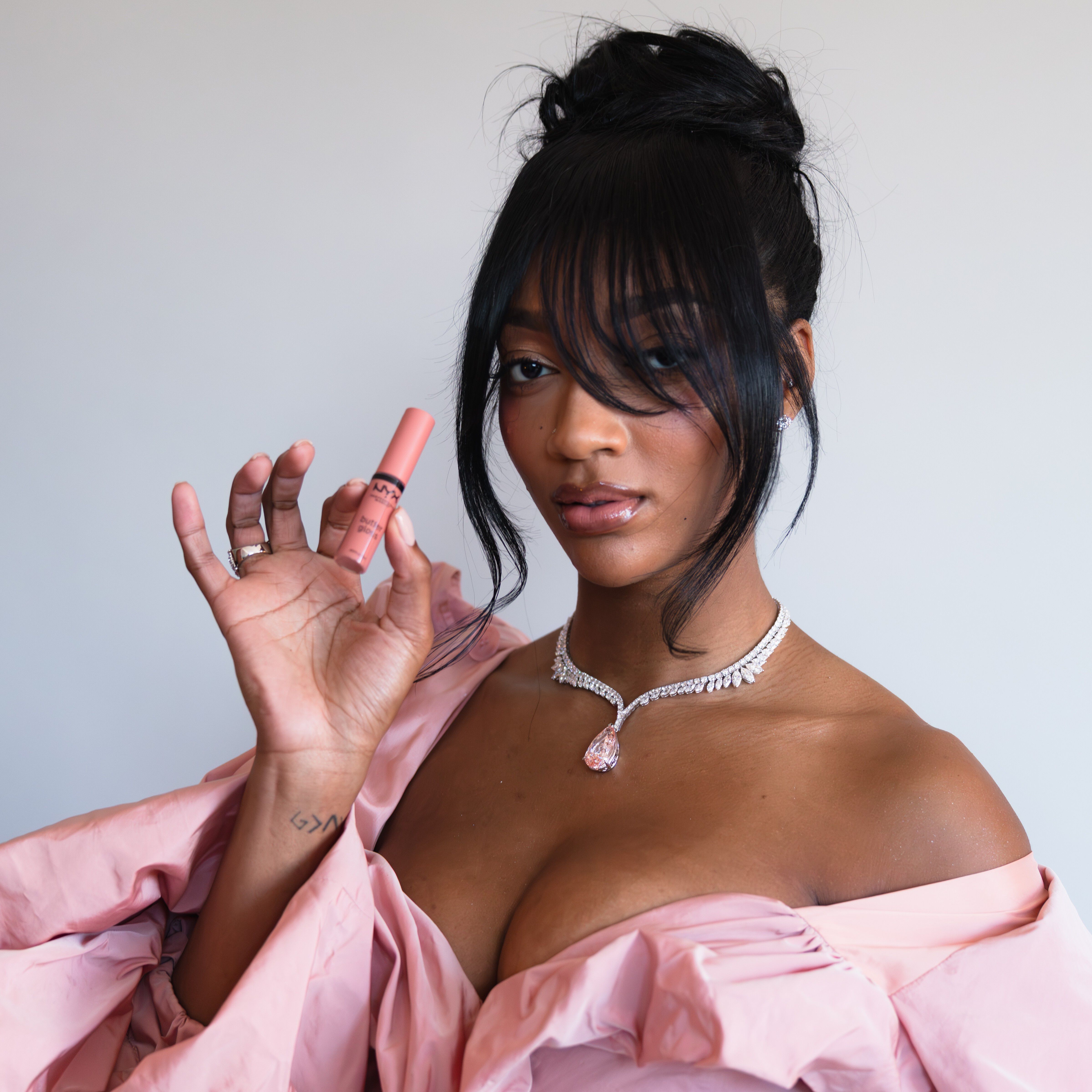 Angel Reese holding butter lip gloss